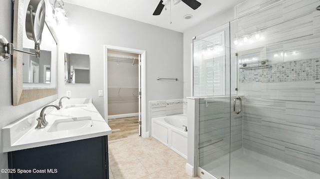 5852 Goleta Cir, Melbourne, FL 32940 - full bathroom featuring a ceiling fan, a stall shower, a garden tub, double vanity, and tile patterned floors