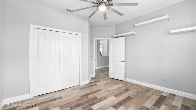 5852 Goleta Cir, Melbourne, FL 32940 - unfurnished bedroom with wood finished floors, baseboards, a closet, and ceiling fan