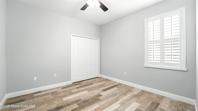 5852 Goleta Cir, Melbourne, FL 32940 - unfurnished bedroom with light wood-type flooring, baseboards, a closet, and ceiling fan