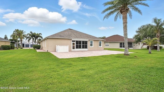 5852 Goleta Cir, Melbourne, FL 32940 - back of property with a patio area, stucco siding, and a lawn