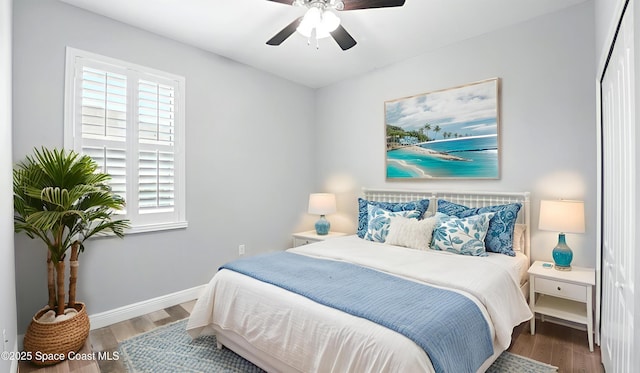 5852 Goleta Cir, Melbourne, FL 32940 - bedroom featuring multiple windows, wood finished floors, and baseboards
