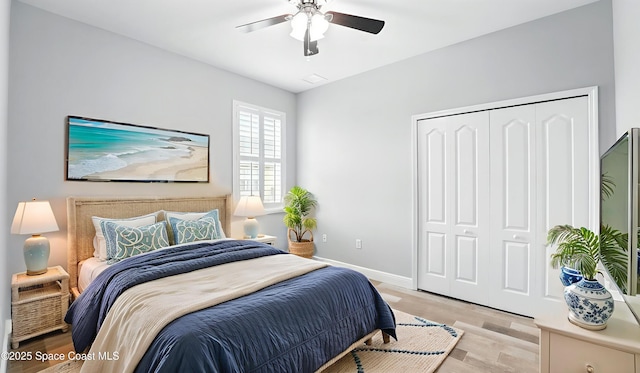 5852 Goleta Cir, Melbourne, FL 32940 - bedroom with a closet, light wood-type flooring, baseboards, and ceiling fan