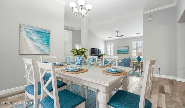 5852 Goleta Cir, Melbourne, FL 32940 - dining room with a chandelier, wood finished floors, baseboards, ornamental molding, and a ceiling fan