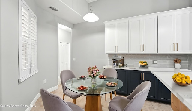 5852 Goleta Cir, Melbourne, FL 32940 - dining space with light tile patterned floors and baseboards