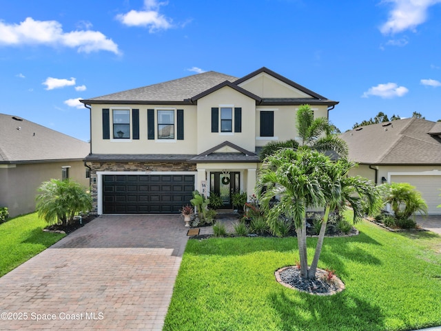 4647 Broomsedge Cir, West Melbourne, FL 32904 - view of front of home featuring stucco siding, decorative driveway, an attached garage, a front yard, and roof with shingles
