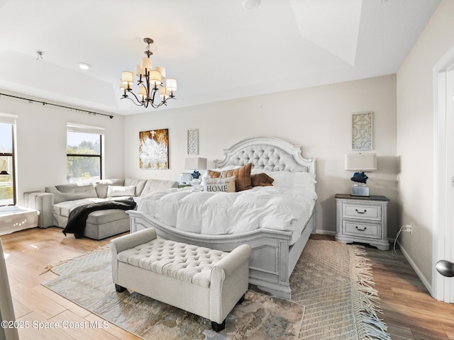 4647 Broomsedge Cir, West Melbourne, FL 32904 - bedroom featuring wood finished floors and a chandelier