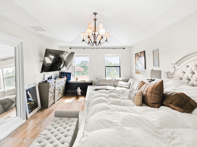 4647 Broomsedge Cir, West Melbourne, FL 32904 - bedroom with a chandelier and light wood-style flooring