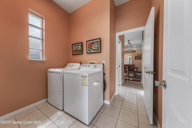 8051 Daventry Dr, Melbourne, FL 32940 - laundry area with washer and clothes dryer, a chandelier, baseboards, and light tile patterned flooring