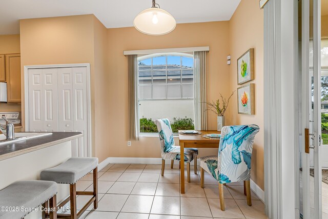 8051 Daventry Dr, Melbourne, FL 32940 - dining area featuring baseboards, plenty of natural light, and light tile patterned floors