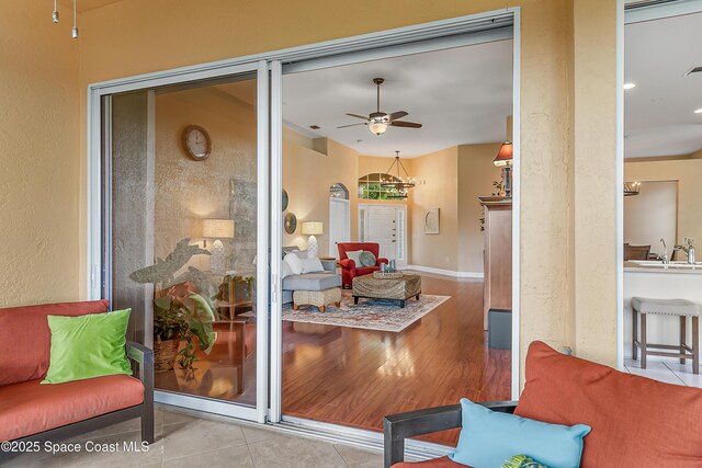 8051 Daventry Dr, Melbourne, FL 32940 - living area with a ceiling fan, a chandelier, and wood finished floors