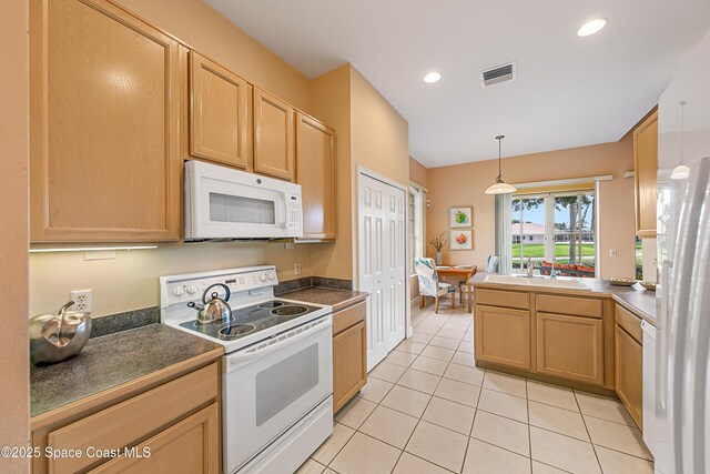 8051 Daventry Dr, Melbourne, FL 32940 - kitchen featuring white appliances, light tile patterned floors, dark countertops, decorative light fixtures, and recessed lighting