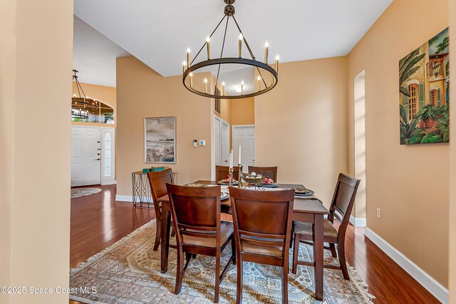 8051 Daventry Dr, Melbourne, FL 32940 - dining room with a chandelier, wood finished floors, and baseboards