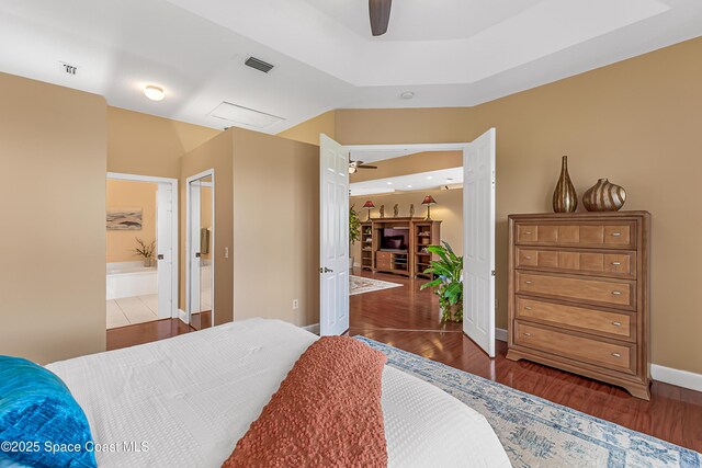 8051 Daventry Dr, Melbourne, FL 32940 - bedroom featuring wood finished floors, baseboards, ceiling fan, and ensuite bathroom