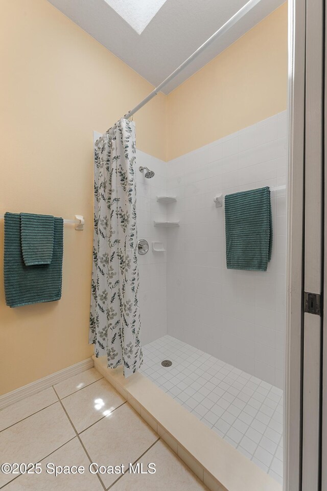 8051 Daventry Dr, Melbourne, FL 32940 - full bath with a shower stall, tile patterned flooring, and baseboards