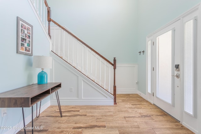 2501 Eldron Blvd SE, Palm Bay, FL 32909 - entrance foyer with light wood-style flooring, a decorative wall, stairway, and a wainscoted wall