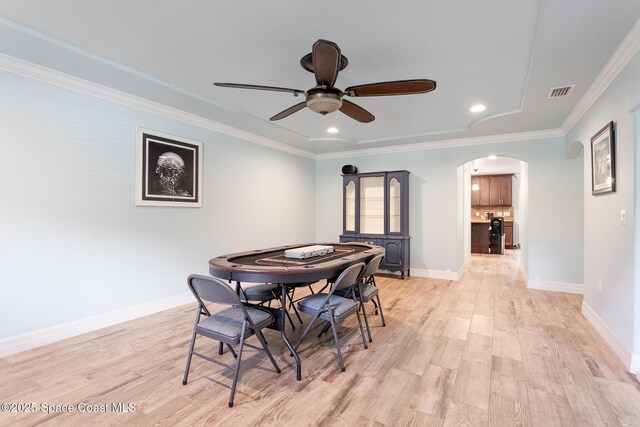 2501 Eldron Blvd SE, Palm Bay, FL 32909 - dining space featuring arched walkways, ceiling fan, light wood-type flooring, ornamental molding, and baseboards