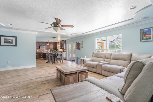 2501 Eldron Blvd SE, Palm Bay, FL 32909 - living area with ornamental molding, a textured ceiling, ceiling fan, plenty of natural light, and light wood-style flooring