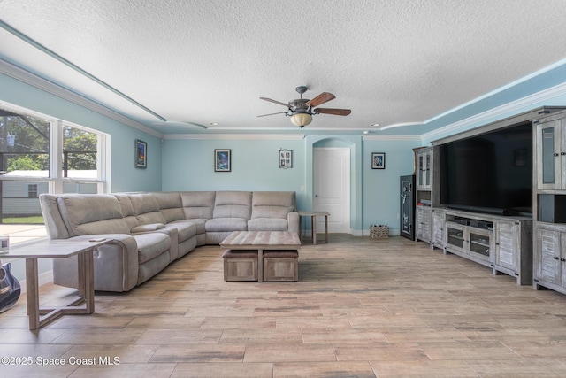 2501 Eldron Blvd SE, Palm Bay, FL 32909 - living area with crown molding, a textured ceiling, light wood-type flooring, arched walkways, and ceiling fan