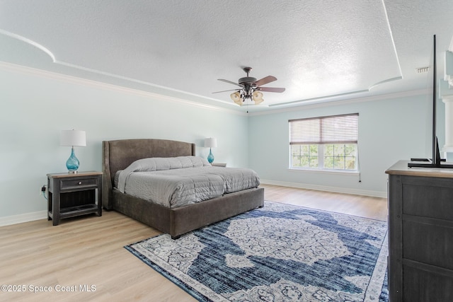 2501 Eldron Blvd SE, Palm Bay, FL 32909 - bedroom featuring light wood-type flooring, ornamental molding, baseboards, a textured ceiling, and ceiling fan