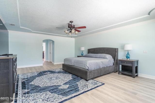 2501 Eldron Blvd SE, Palm Bay, FL 32909 - bedroom with arched walkways, wood finished floors, ornamental molding, baseboards, and a textured ceiling