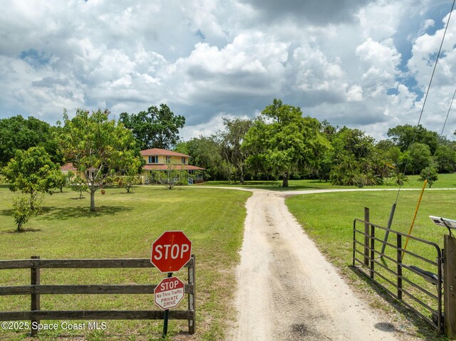2280 Grove St, Titusville, FL 32796 - view of dirt / gravel road with view of wooded area