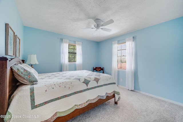 2280 Grove St, Titusville, FL 32796 - carpeted bedroom featuring ceiling fan, baseboards, and a textured ceiling