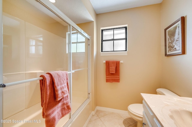 2280 Grove St, Titusville, FL 32796 - full bathroom featuring toilet, vanity, bath / shower combo with glass door, tile patterned flooring, and baseboards