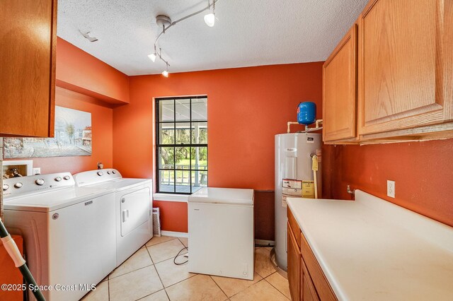 2280 Grove St, Titusville, FL 32796 - laundry area with washer and dryer, electric water heater, cabinet space, light tile patterned flooring, and rail lighting