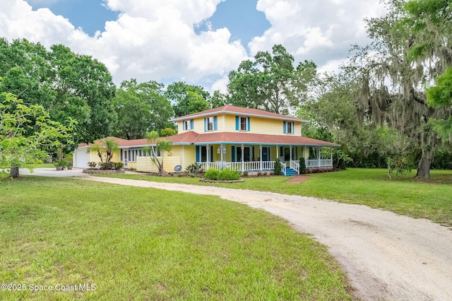 2280 Grove St, Titusville, FL 32796 - farmhouse-style home featuring concrete driveway, covered porch, a front lawn, and an attached garage
