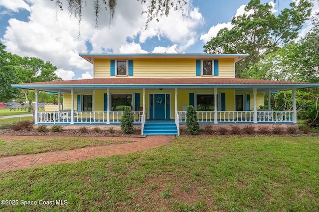 2280 Grove St, Titusville, FL 32796 - farmhouse-style home with covered porch and a front lawn