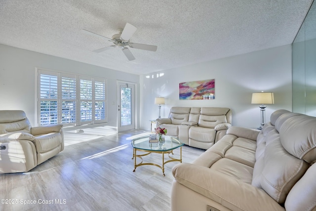 70 Royal Oak Ct Unit 206, Vero Beach, FL 32962 - living area with a textured ceiling, wood finished floors, and ceiling fan