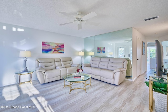 70 Royal Oak Ct Unit 206, Vero Beach, FL 32962 - living area with a ceiling fan, light wood-style flooring, a textured ceiling, and baseboards
