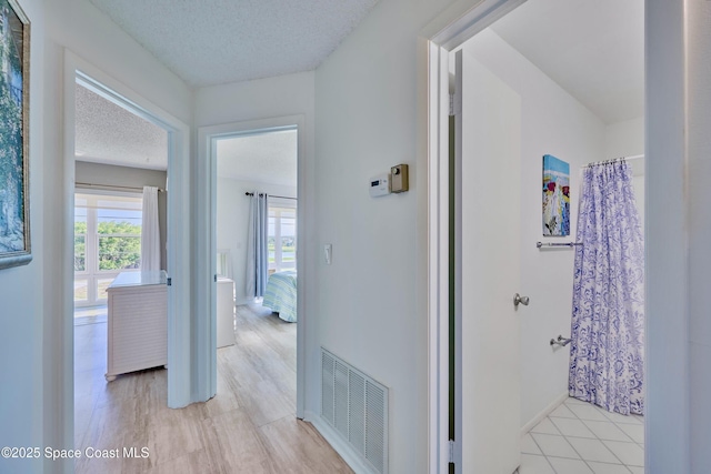 70 Royal Oak Ct Unit 206, Vero Beach, FL 32962 - corridor with a textured ceiling and baseboards