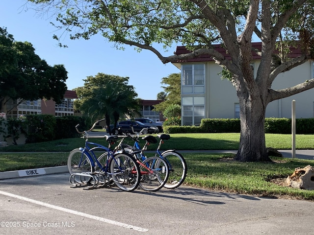 70 Royal Oak Ct Unit 206, Vero Beach, FL 32962 - surrounding community with a lawn and uncovered parking
