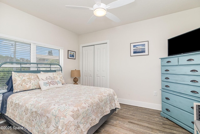 6015 Turtle Beach Ln Unit 204, Cocoa Beach, FL 32931 - bedroom with baseboards, wood finished floors, a closet, and ceiling fan