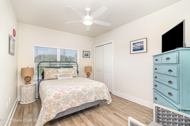 6015 Turtle Beach Ln Unit 204, Cocoa Beach, FL 32931 - bedroom with light wood-type flooring, a closet, baseboards, and a ceiling fan