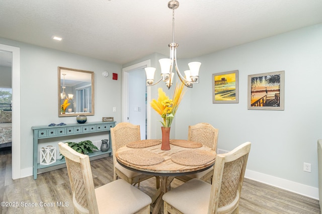 6015 Turtle Beach Ln Unit 204, Cocoa Beach, FL 32931 - dining area featuring a chandelier, light wood-style flooring, baseboards, and recessed lighting