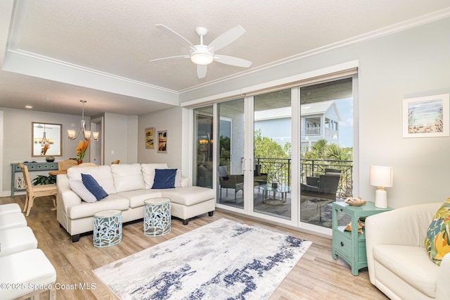 6015 Turtle Beach Ln Unit 204, Cocoa Beach, FL 32931 - living room with light wood-style flooring, a chandelier, ceiling fan, and ornamental molding