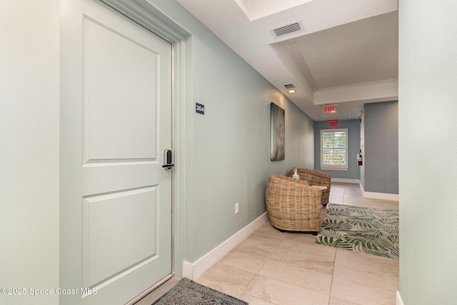 6015 Turtle Beach Ln Unit 204, Cocoa Beach, FL 32931 - hallway featuring baseboards, a raised ceiling, and tile patterned flooring