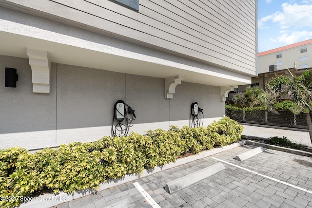 6015 Turtle Beach Ln Unit 204, Cocoa Beach, FL 32931 - exterior view of a parking lot, stucco siding, and car charger