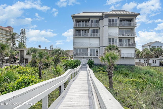 6015 Turtle Beach Ln Unit 204, Cocoa Beach, FL 32931 - rear view of house with a standing seam roof, metal roof, and stucco siding