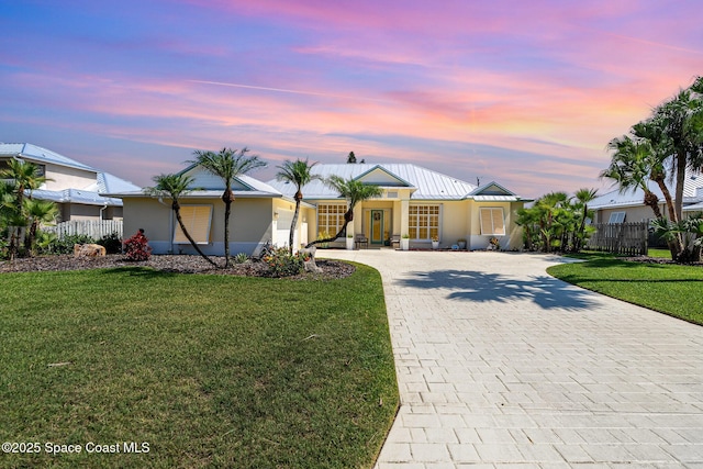 140 Miami Ave, Indialantic, FL 32903 - single story home with decorative driveway, a garage, metal roof, stucco siding, and a standing seam roof