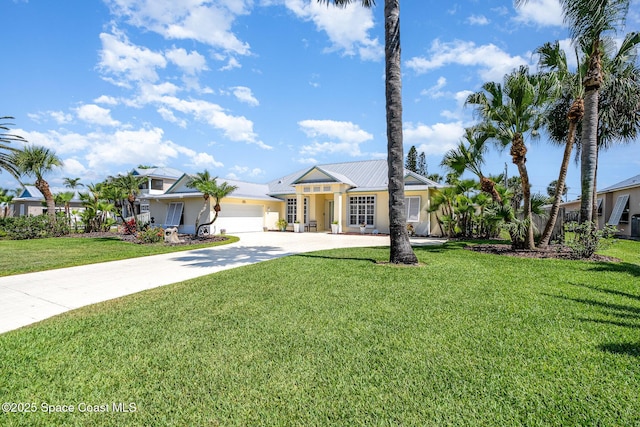 140 Miami Ave, Indialantic, FL 32903 - view of front of property with concrete driveway, an attached garage, and a front lawn