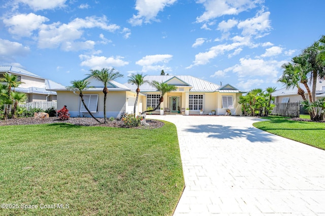 140 Miami Ave, Indialantic, FL 32903 - single story home with decorative driveway, stucco siding, a standing seam roof, and metal roof