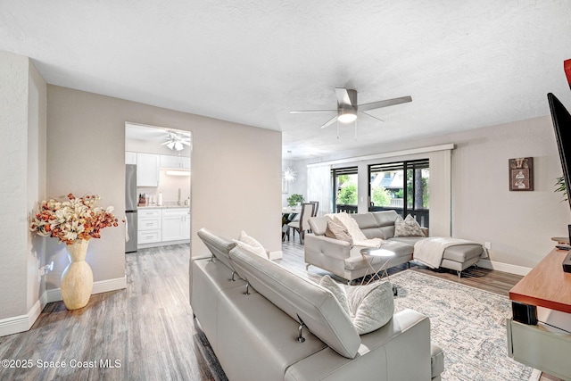 9040 York Ln Unit 16G, West Melbourne, FL 32904 - living room featuring ceiling fan, light wood-style flooring, and baseboards