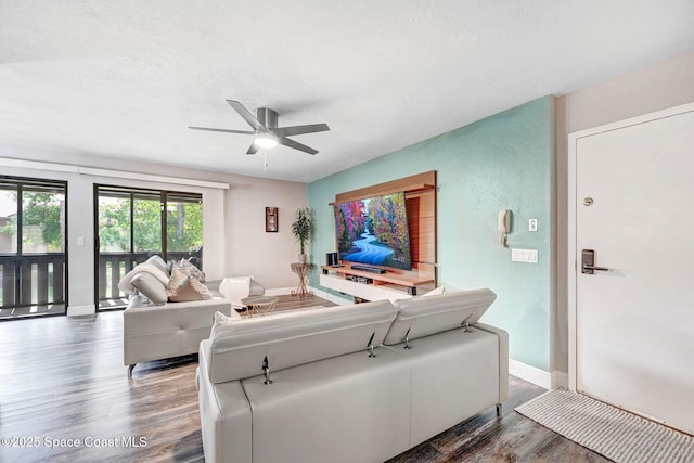 9040 York Ln Unit 16G, West Melbourne, FL 32904 - living area featuring wood finished floors, ceiling fan, and baseboards