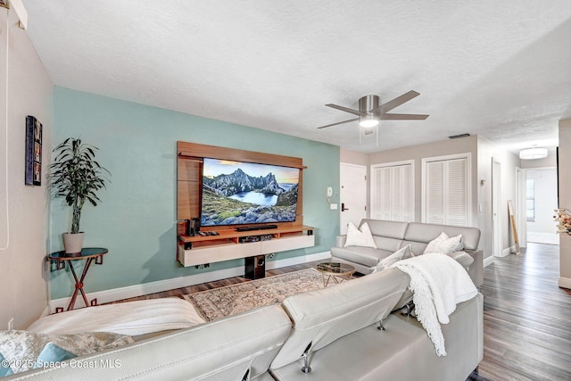 9040 York Ln Unit 16G, West Melbourne, FL 32904 - living room featuring wood finished floors, baseboards, ceiling fan, and a textured ceiling