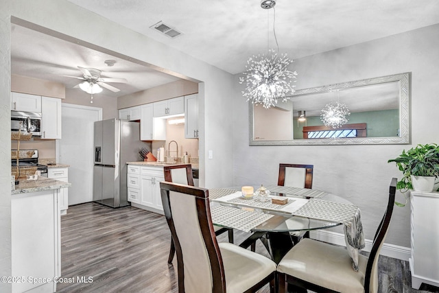 9040 York Ln Unit 16G, West Melbourne, FL 32904 - dining area with wood finished floors, a chandelier, and ceiling fan