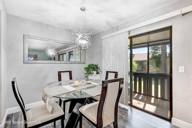 9040 York Ln Unit 16G, West Melbourne, FL 32904 - dining area featuring a chandelier, wood finished floors, a textured wall, and baseboards