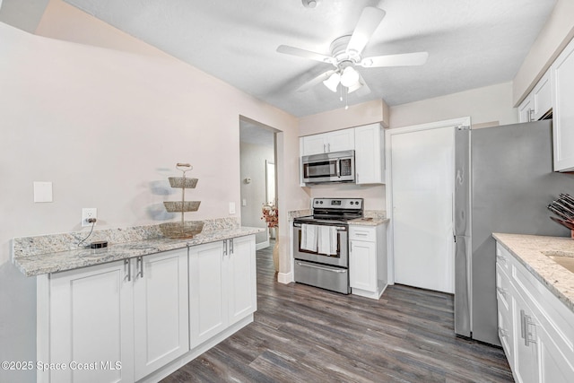 9040 York Ln Unit 16G, West Melbourne, FL 32904 - kitchen with appliances with stainless steel finishes, ceiling fan, dark wood-style flooring, and white cabinetry